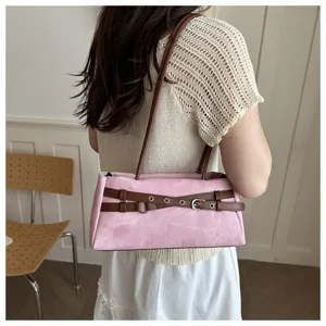 Pink suede shoulder bag with brown belt detail, stylish underarm handbag for women daily wear.