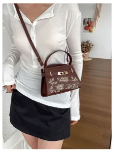 Brown leather women's handbag crossbody bag with floral embroidery and gold hardware.