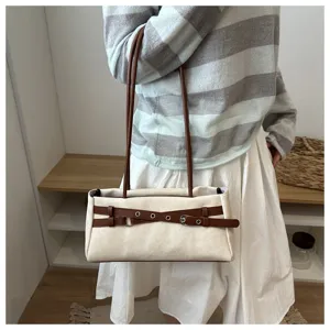 Close-up detail of the stylish contrast belt shoulder bag showing premium fabric texture.
