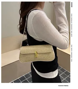 Detail view of the stylish straw underarm shoulder bag with chic metal lock closure.