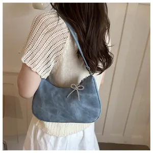 Retro blue suede underarm shoulder bag with rhinestone bow for chic daily commute.