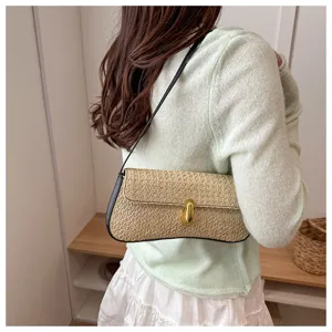 Women stylish straw woven shoulder baguette bag with elegant metal lock closure detail