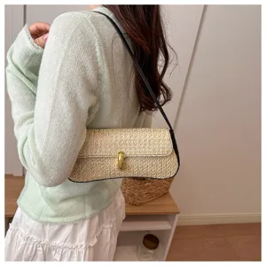 Chic straw shoulder bag for women, trendy underarm handbag with gold lock and stylish design.