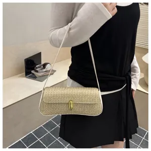 Detail view of stylish straw shoulder bag with metallic lock closure for daily fashion wear.