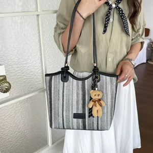 Stylish striped woven canvas tote bag with cute bear pendant for women daily commute.