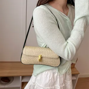 Korean style straw woven shoulder underarm bag for women with chic metal lock and black strap.