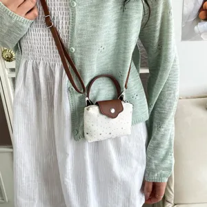 Mini white crossbody bag with brown handle and strap, cute star pattern chic purse.