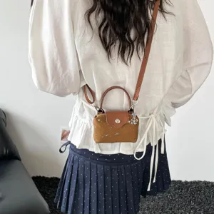 Mini brown leather crossbody shoulder bag with top handle and star studs for women stylish
