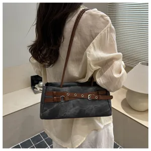 Stylish denim underarm shoulder bag with contrast brown leather belt detail for daily wear.