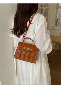 Minimalist retro brown crossbody bag with top handle and stylish bubble texture for women.