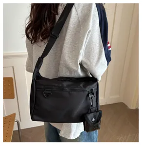 Casual black crossbody messenger bag for daily use, lightweight stylish shoulder bag with small pouch.