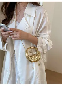 Fashion gold metallic mini chain bag with unique circular sculptural design and chic retro vibe.