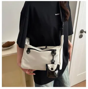 Stylish casual white crossbody shoulder bag with small pouch, spacious daily commuter bag.
