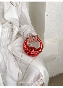 Red crescent moon shaped chain mini bag detail view, stylish women crossbody handbag chic.
