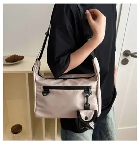 Detail view of the casual nylon crossbody shoulder bag, featuring multiple pockets and straps.