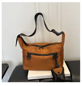 Detailed view of the brown nylon crossbody shoulder bag with multi-pocket and small pouch.