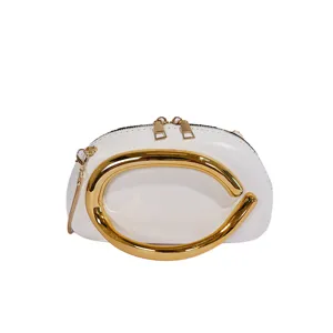 Mini round evening bag with gold metal handle and chain strap for women chic crossbody style.