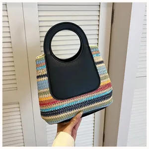 Detail view of woven straw handbag featuring a stylish black round handle and colorful striped design.