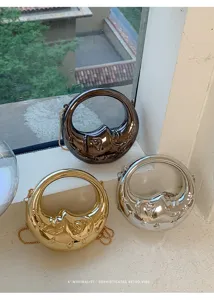Close-up detail of trendy metallic round mini crossbody handbags on retro window ledge scene.
