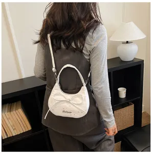 Chic white crossbody bag for women featuring a cute bow and star pattern. Compact.
