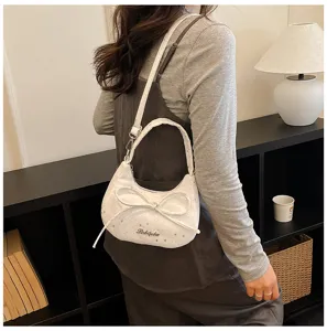 White dumpling shoulder bag with bow and star print, chic crossbody bag for women.