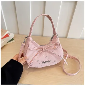 Pink canvas crossbody bag with cute bow and star pattern, chic handbag for women.