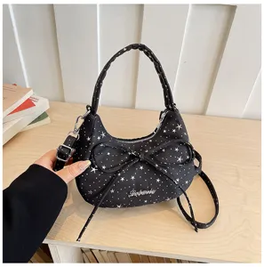 Chic black star print crossbody bag with bow detail, stylish shoulder handbag for women details.