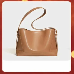 Details of the genuine leather brown shoulder bag, showing soft texture and vintage bucket design.