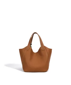 Vue detaille d'un sac seau en cuir marron avec des coutures blanches pour le travail quotidien.