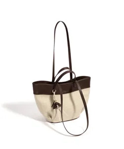 Detailed view of the two-tone canvas and brown leather tote bag showing its texture and hardware.