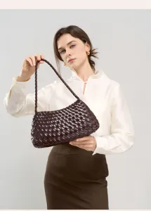 Woven leather shoulder bag for women, elegant commuter handbag with woven design.
