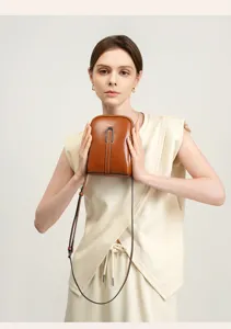 Genuine leather phone crossbody bag detail, chic brown mini shoulder bag for women daily use.