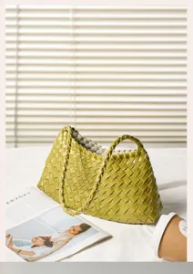 Woven leather shoulder bag for women, stylish green handmade basket handbag for daily commute.