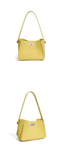Elegant yellow leather shoulder bag, stylish commuter tote with metal turn-lock closure.
