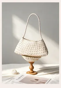 Beige woven shoulder bag for women, stylish leather underarm handbag, elegant daily commuter purse.