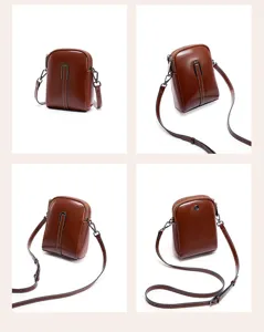 Close-up detail of the brown leather crossbody phone bag, featuring a metallic vertical front bar.