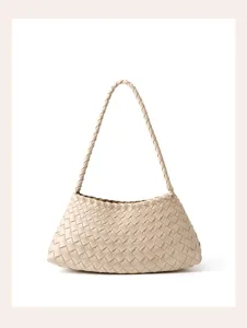 Woven leather shoulder bag detail, elegant beige underarm handbag close-up view design.