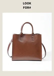 Brown leather handbag detail, large capacity tote bag, stylish commuting shoulder bag.