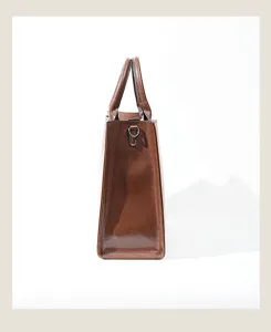 Premium leather handbag side detail, brown tote bag profile view showcasing fine craftsmanship.