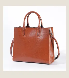 Detailed view of the brown leather woman handbag, showing smooth texture and exquisite stitching.