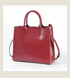 Detailed view of the dark red leather tote bag showing fine texture and sturdy handles.