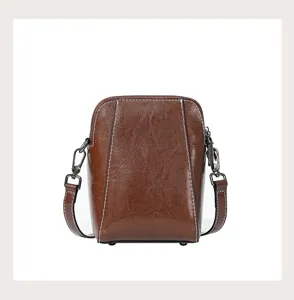 Brown oil wax leather crossbody bag for women, stylish small leather phone bag with metal hardware.