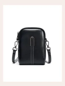 Detailed view of a stylish black leather mini crossbody phone bag with elegant white stitching.