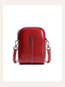 Red leather phone crossbody bag detail showing vertical stripe design and metal hardware.