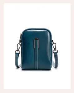 Genuine leather small phone crossbody bag for women, stylish dark teal mini shoulder handbag.