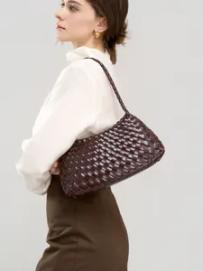 Woven leather shoulder bag for women, stylish dark brown underarm handbag, elegant daily commute purse.