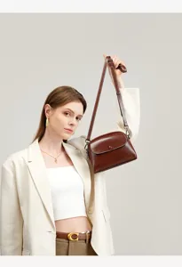 Detailed view of women's vintage brown leather shoulder crossbody bag with elegant flap design.