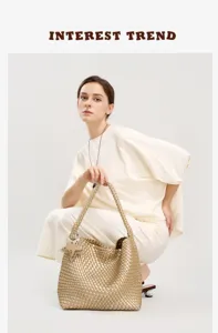 Detailed view of the stylish woven leather hobo tote bag in gold with star charm accessory.