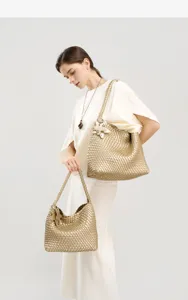 Detail shot of the luxury woven shoulder tote bag and handbag set in elegant gold finish for daily use.