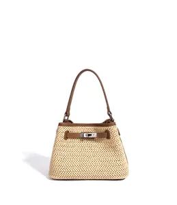 Detailed view of women straw woven handbag with leather trim, stylish resort bucket crossbody bag.